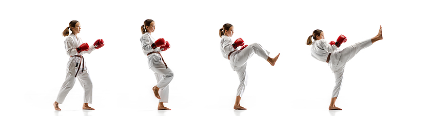 Image showing Confident junior in kimono practicing taekwondo combat, martial arts