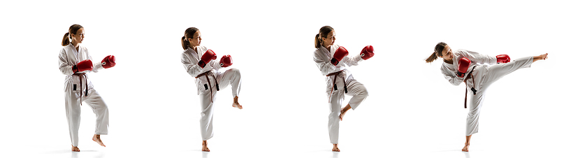 Image showing Confident junior in kimono practicing taekwondo combat, martial arts