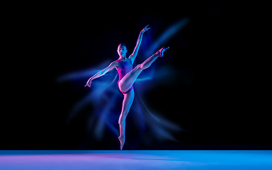 Image showing Young and graceful ballet dancer isolated on black studio background in neon mixed light