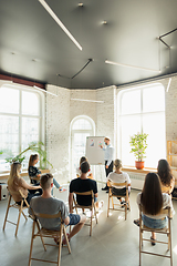 Image showing Male speaker giving presentation in hall at university workshop. Audience or conference hall