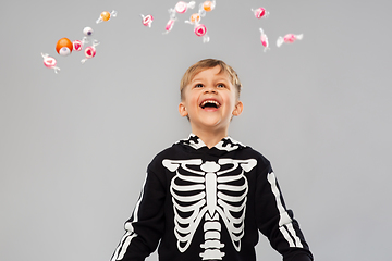 Image showing boy with candies trick-or-treating on halloween