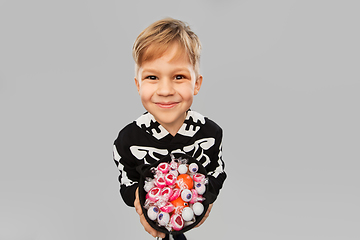 Image showing boy with candies trick-or-treating on halloween