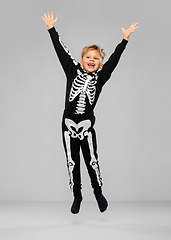 Image showing happy boy in halloween costume of skeleton jumping