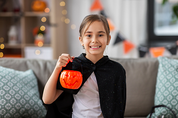 Image showing girl in halloween costume with bat cape at home