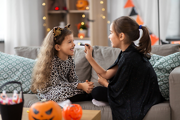 Image showing girls doing face painting on halloween at home