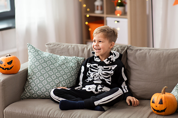 Image showing happy boy in halloween costume of skeleton at home