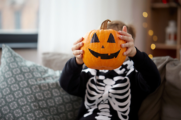 Image showing boy in halloween costume with jack-o-lantern