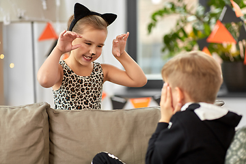 Image showing kids in halloween costumes playing at home