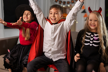 Image showing kids in halloween costumes s having fun at home