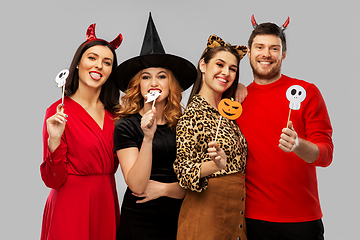 Image showing friends in halloween costumes with party props