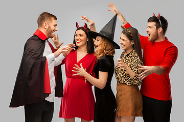 Image showing friends in halloween costumes scaring each other