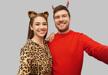 Image showing happy couple in halloween costumes taking selfie
