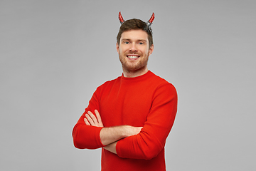 Image showing happy man in halloween costume of devil over grey