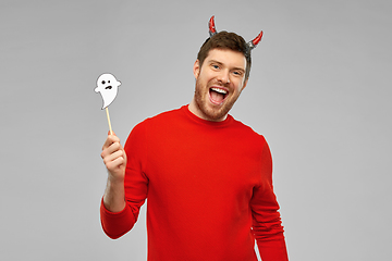 Image showing happy man in halloween costume of devil over grey