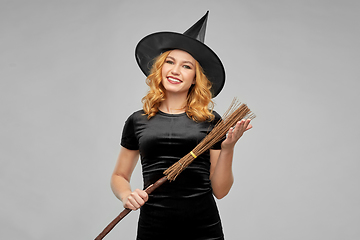 Image showing woman in halloween costume of witch with broom