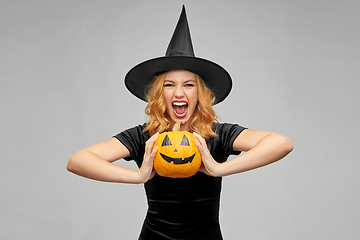 Image showing woman in halloween costume of witch with pumpkin