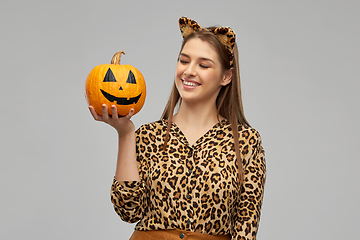 Image showing woman in halloween costume of leopard with pumpkin