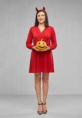 Image showing woman in halloween costume of devil with pumpkin