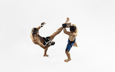 Image showing Two professional MMA fighters boxing isolated on white studio background, dynamic and motion. Top view