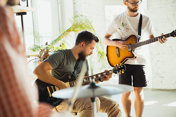 Image showing Musician band jamming together in art workplace with instruments