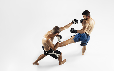 Image showing Two professional MMA fighters boxing isolated on white studio background, dynamic and motion. Top view