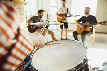 Image showing Musician band jamming together in art workplace with instruments