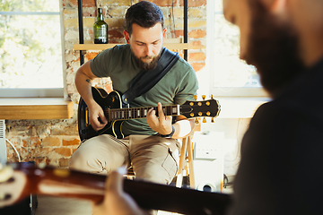 Image showing Musician band jamming together in art workplace with instruments