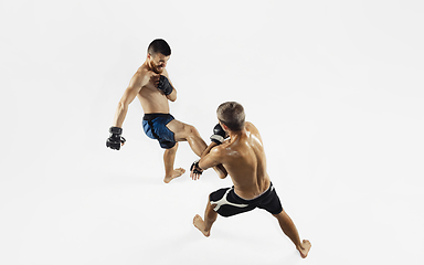 Image showing Two professional MMA fighters boxing isolated on white studio background, dynamic and motion. Top view