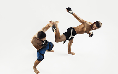 Image showing Two professional MMA fighters boxing isolated on white studio background, dynamic and motion. Top view