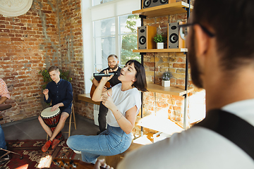 Image showing Musician band jamming together in art workplace with instruments