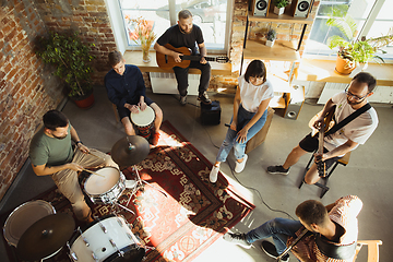 Image showing Musician band jamming together in art workplace with instruments