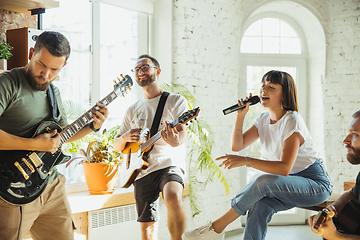 Image showing Musician band jamming together in art workplace with instruments