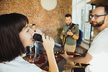 Image showing Musician band jamming together in art workplace with instruments