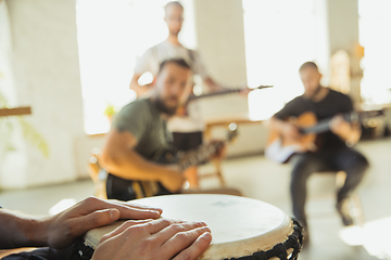 Image showing Musician band jamming together in art workplace with instruments