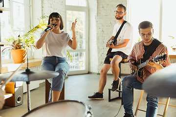 Image showing Musician band jamming together in art workplace with instruments