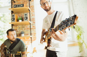 Image showing Musician band jamming together in art workplace with instruments