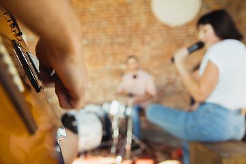 Image showing Musician band jamming together in art workplace with instruments