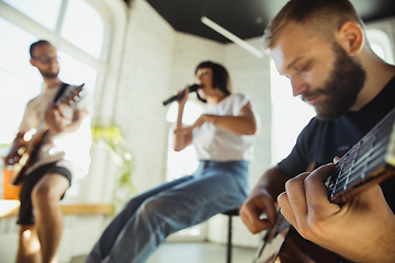 Image showing Musician band jamming together in art workplace with instruments