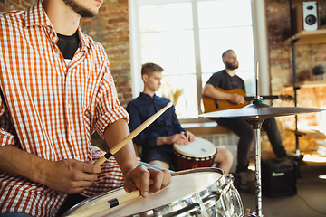 Image showing Musician band jamming together in art workplace with instruments