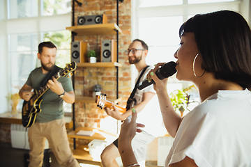 Image showing Musician band jamming together in art workplace with instruments