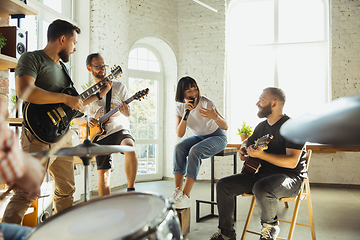 Image showing Musician band jamming together in art workplace with instruments