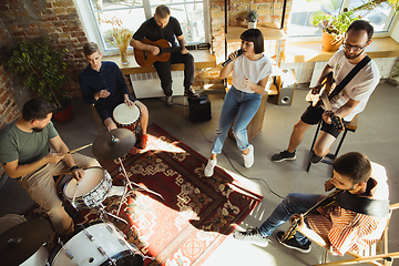 Image showing Musician band jamming together in art workplace with instruments