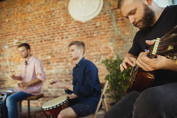 Image showing Musician band jamming together in art workplace with instruments