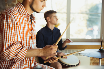 Image showing Musician band jamming together in art workplace with instruments