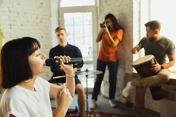 Image showing Musician band jamming together in art workplace with instruments