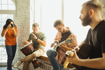 Image showing Musician band jamming together in art workplace with instruments