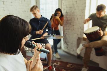 Image showing Musician band jamming together in art workplace with instruments