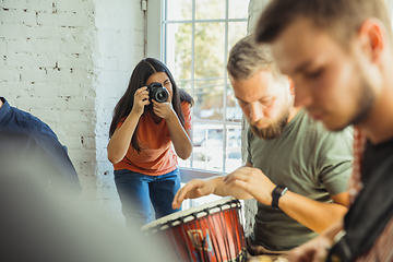 Image showing Musician band jamming together in art workplace with instruments