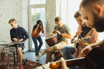 Image showing Musician band jamming together in art workplace with instruments