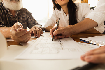 Image showing Male architect-engineer presents project of future house for young family.